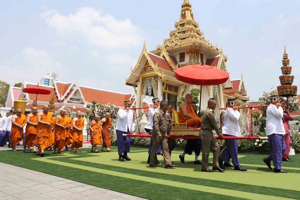  Thai Buddhist monks walk in during the cremation ceremony for Vichai