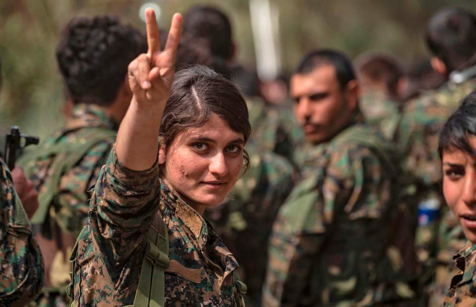  A SDF fighter flashes the V for Victory sign following the defeat of ISIS