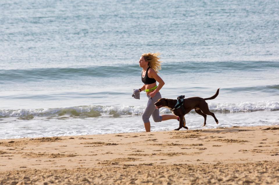  A runner jogs on the shore in Bournemouth