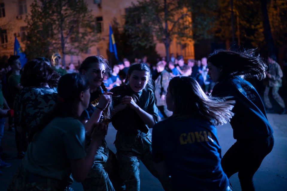 Members of the nationalist group Sokil, the youth wing of the Svoboda party fight at a concert