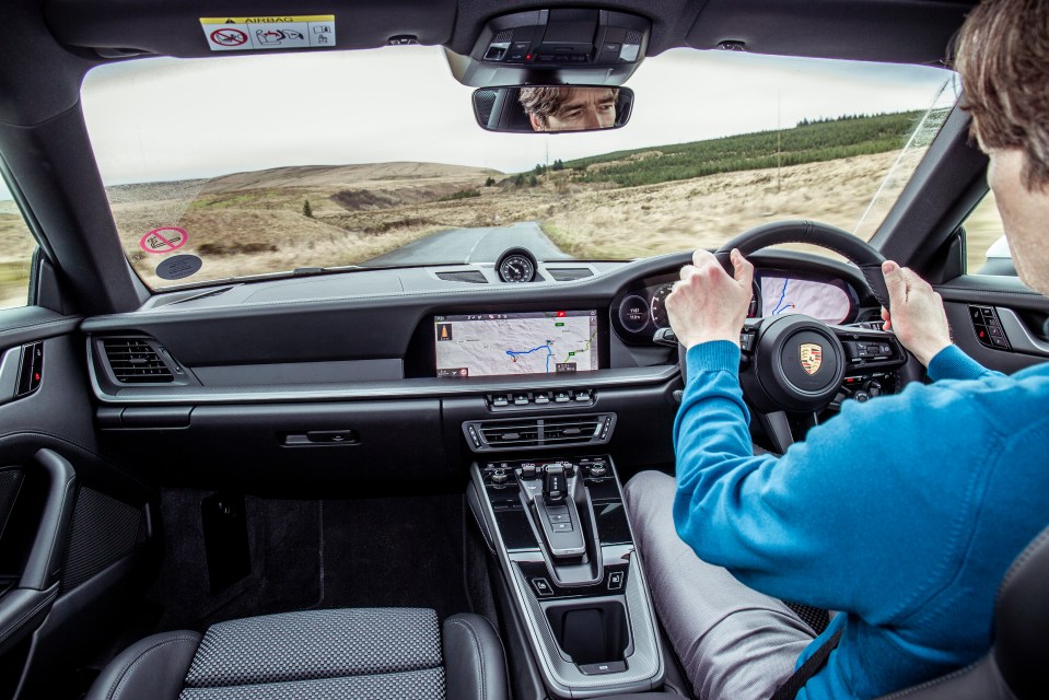  The horizontal dash is a nod to 911s of old and the analogue rev counter is now flanked by two digital screens.