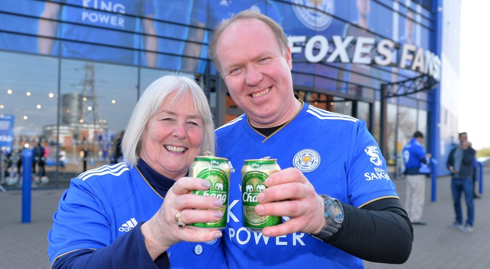  Supporters raise a can to their late former chairman