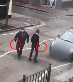  Two thugs are seen brandishing weapons after allegedly carrying out an attack near a mosque in East London today