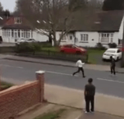 A man can be seen running from the two men yelling at him