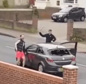 One man can be seen wielding a bat and smashing a car