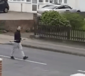 A man can be seen walking down the street in Medway, Kent