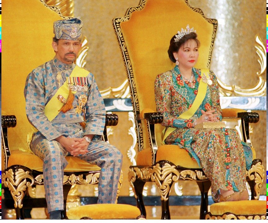  Sultan Hassanal Bolkia and second wife Queen Hajah Mariam sit on the throne during an investiture ceremony for the Sultan's 50th birthday celebrations