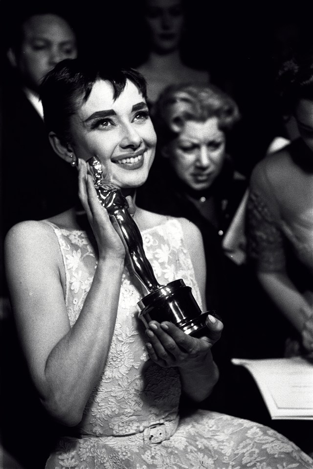 Audrey Hepburn holding an Oscar award she won for her performance in the movie ‘Roman Holiday’ at the Academy Awards ceremony in New York City