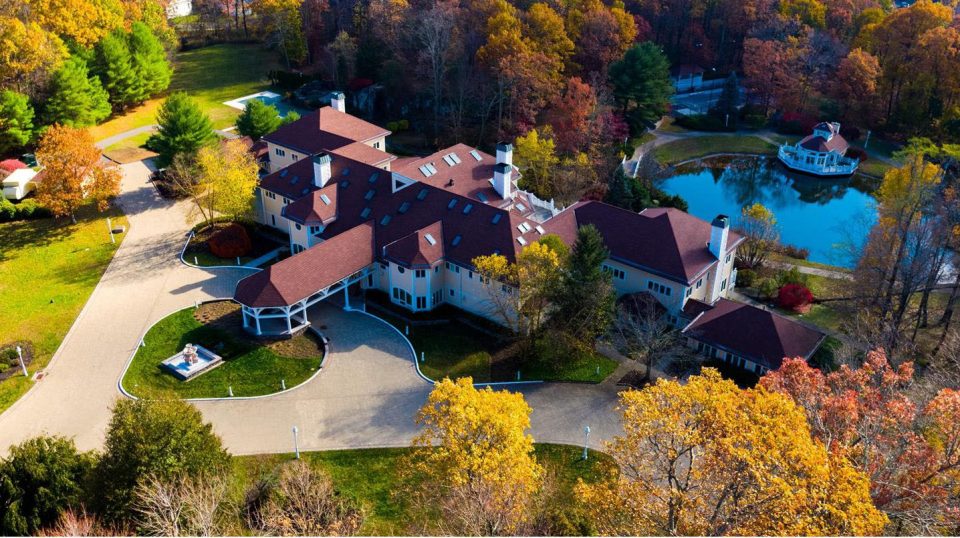  The property is surround by trees and has a large winding driveway