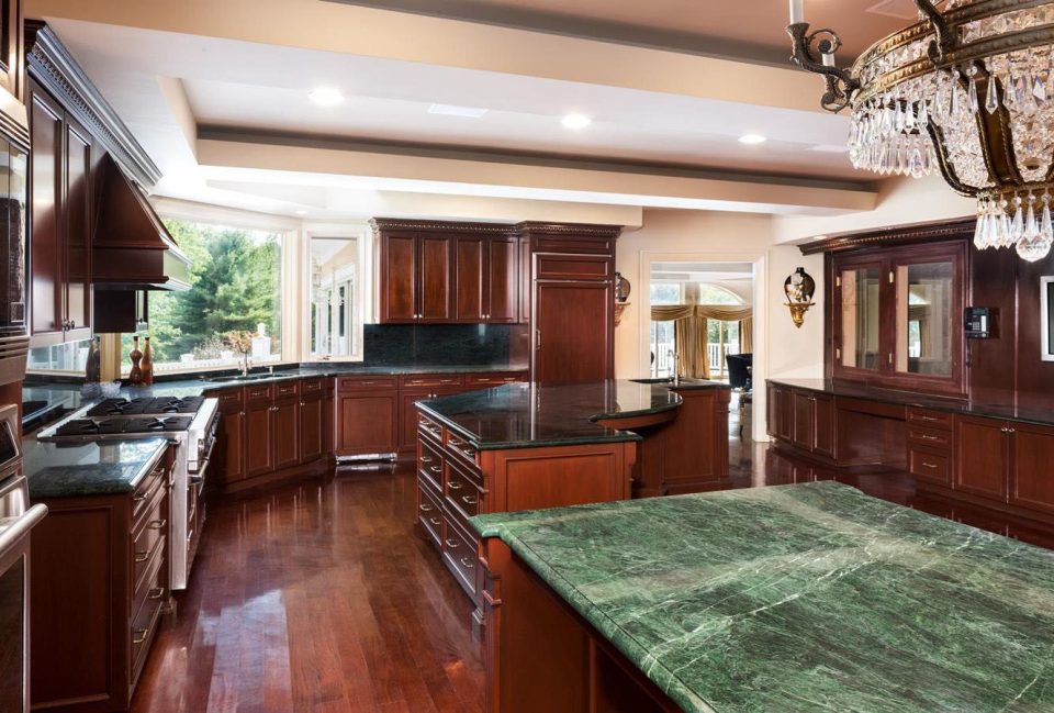  This is one of the nine kitchens in the mansion, featuring marble worktops and a crystal chandelier