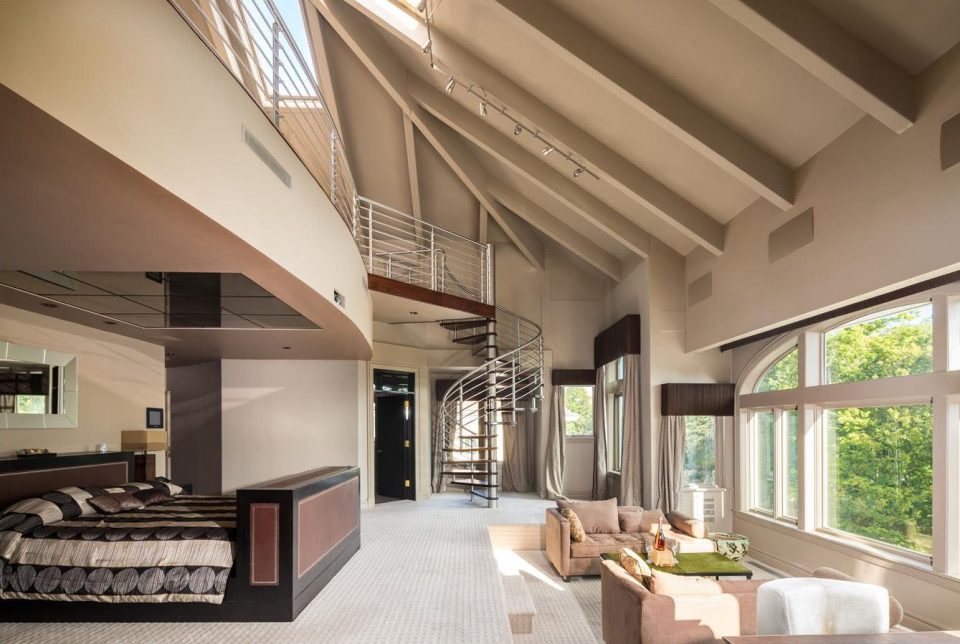  One of the 21 bedrooms featuring sofas and a spiral staircase