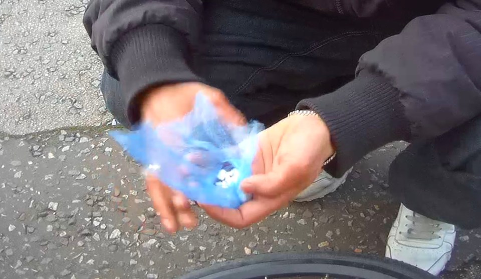  The dealer shows the merchandise in broad daylight on an East London street