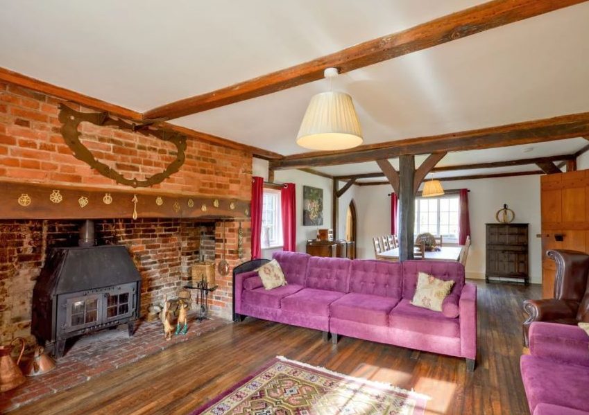  The living room has a wood burner and beautiful period features