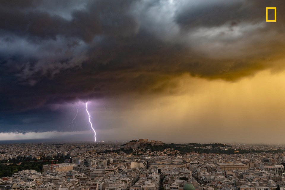  A lightning strikes the shoreline of Attica behind the Acropolis of Athens, Greece, during a severe summer thunderstorm on June 23, 2018. By Alexandros Maragos.