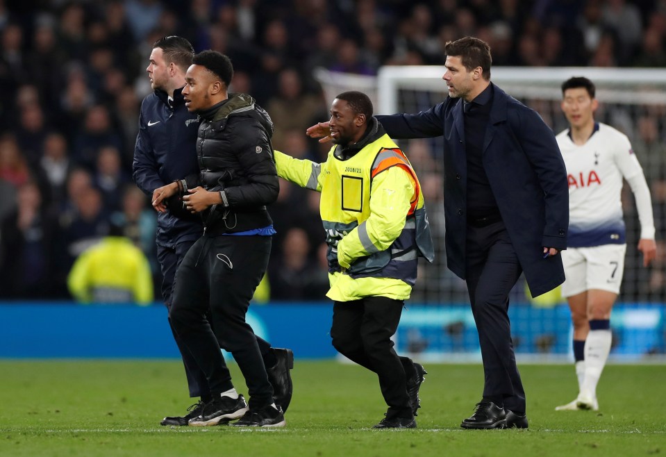 The fan was eventually restrained by stewards and hauled off the pitch