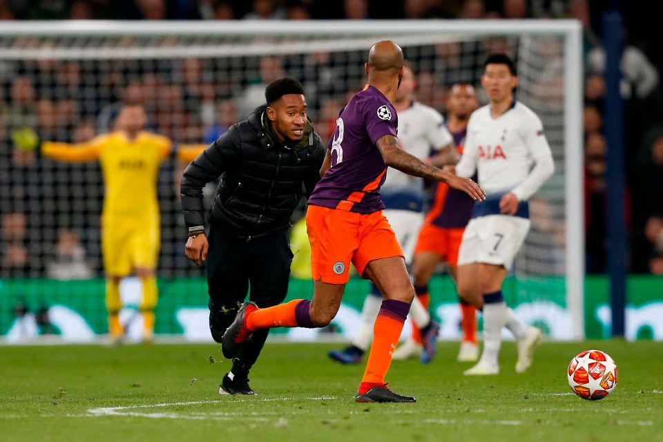 A pitch invader made it to the centre-circle and looked to grab the ball from Delph