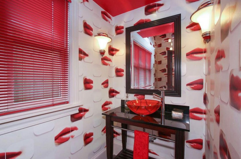  The colour red throughout this bathroom is enhanced by the odd lip wallpaper