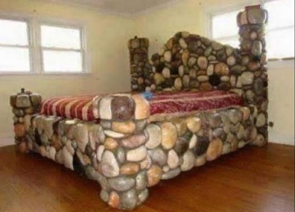  This grand bed would certainly be difficult to move due to the heavy stonework