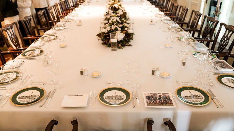  The table was laid out with the iconic plates that show Augusta National's clubhouse