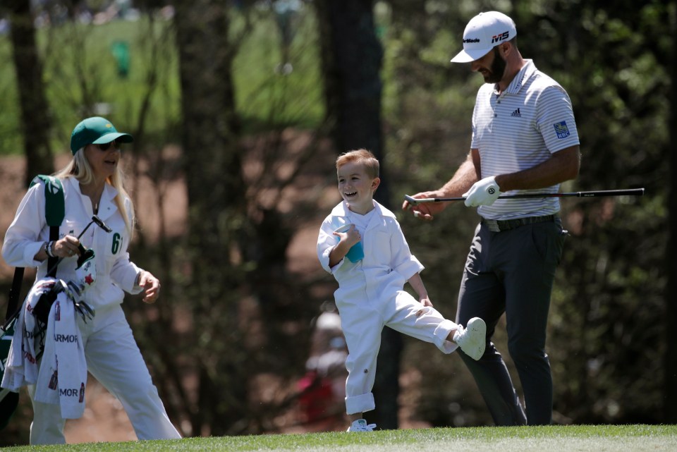  Dustin Johnson with his son Tatum during the par-three contest