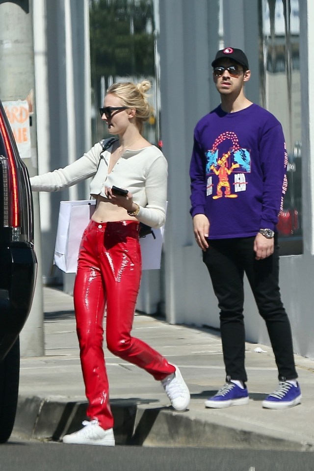  Sophie Turner looked red hot in eye-catching PVC trousers as she went shopping with fiancé Joe Jonas in LA yesterday