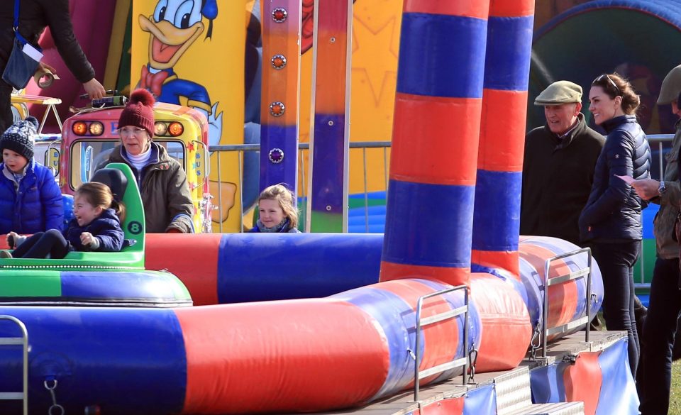 Stylish Kate keeps a watchful eye on Charlotte as she is on carnival ride