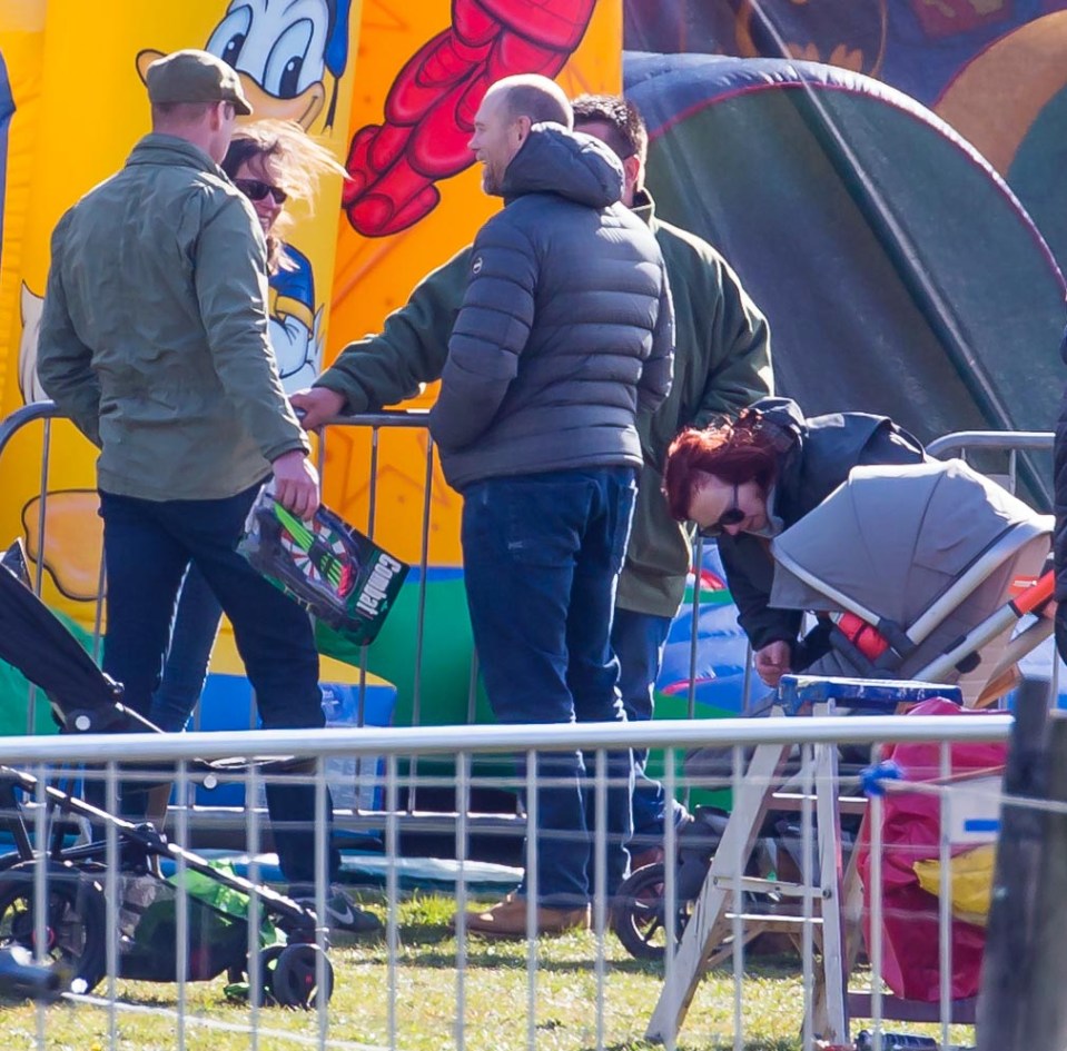 Prince William and Mike Tindall have a chat next to the bouncy castle