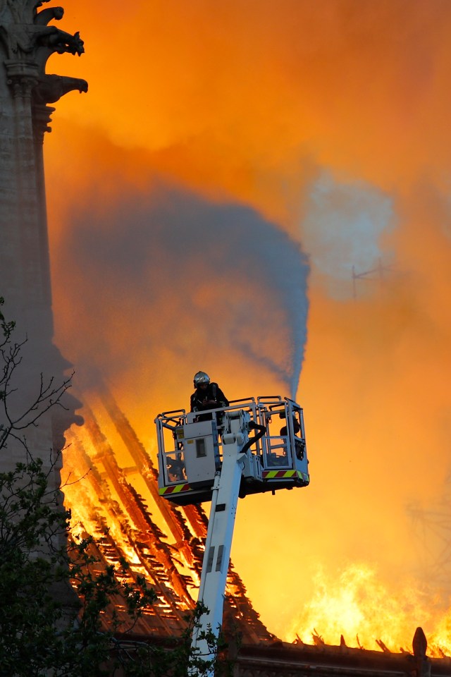  Firefighters trying to extinguish the out-of-control blaze on April 15