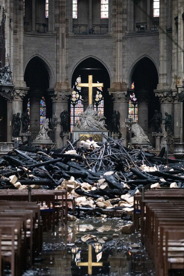  The Decent from the Cross statue by Nicolas Coustou is seen among the charred rubble, a surviving relic from the inferno