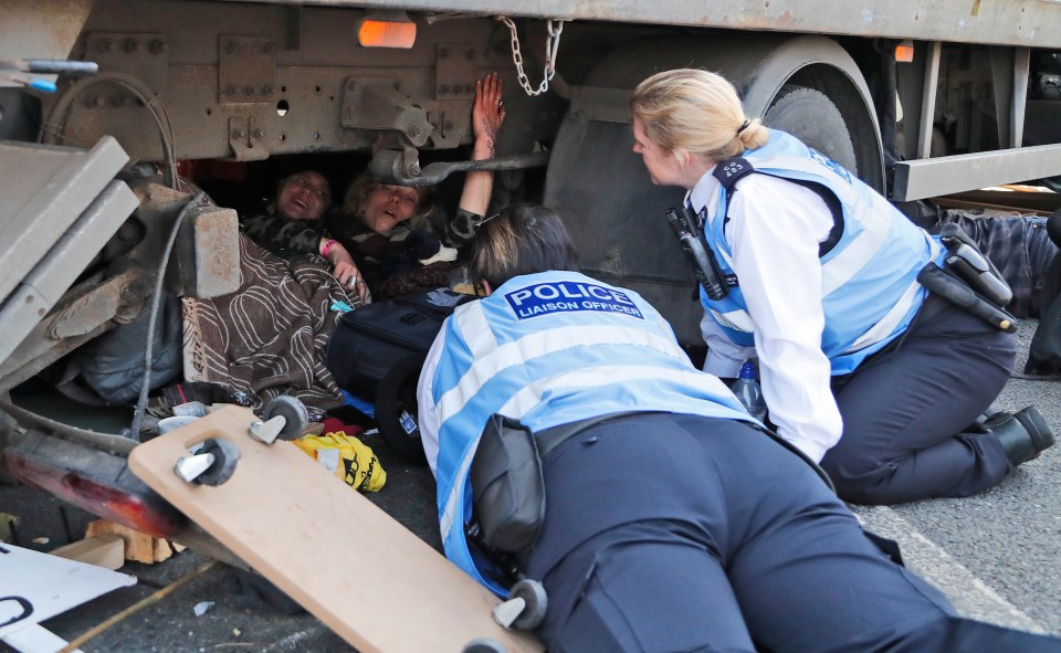  Police speak to protesters under vans at Waterloo Bridge as they refuse to move