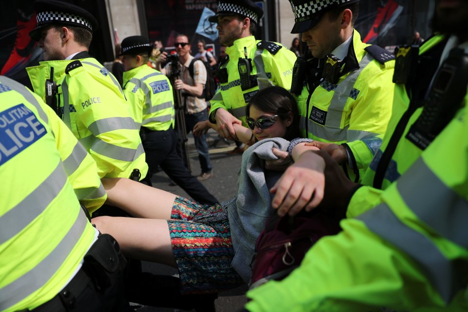  A woman is carried away from Oxford Circus after police ordered protesters to move on