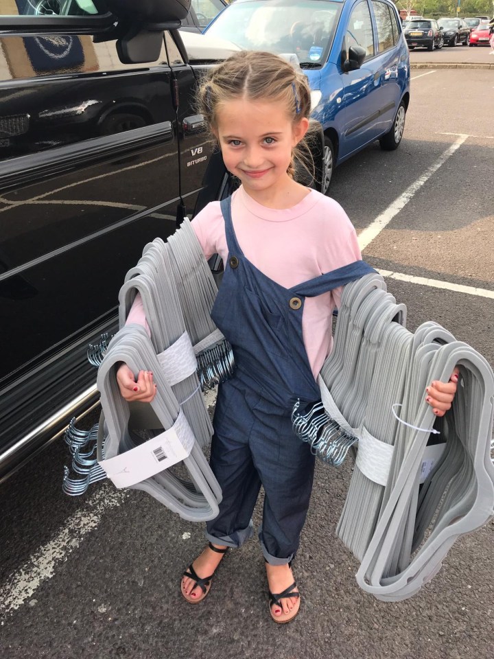 The Style Sisters set about bringing in matching grey hangers to make the wardrobe look chic, and little Hollie pitched in to help