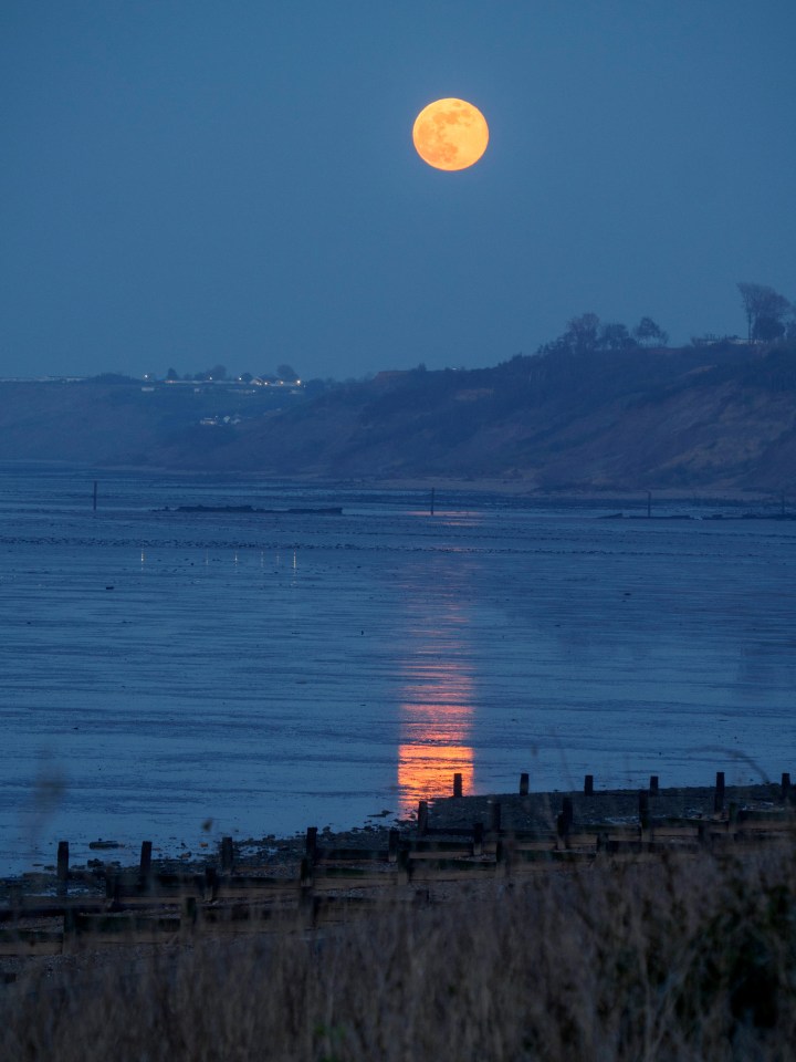 Pink moon rising above the cliffs in Minster-on-sea, Kent, tonight