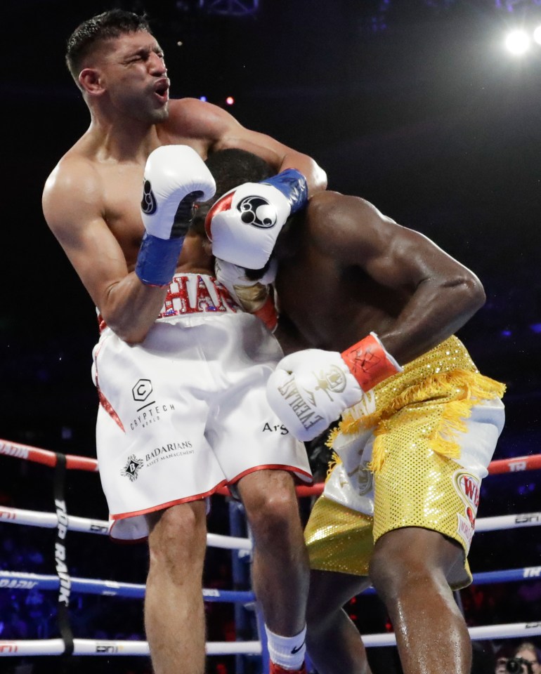 Khan, 32, reacts after being hit below the belt by Crawford at Madison Square Garden