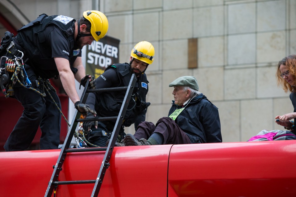  One of the first members of Extinction Rebellion, Phil Kingston, 83, was removed from a DLR train by police after gluing himself to the roof