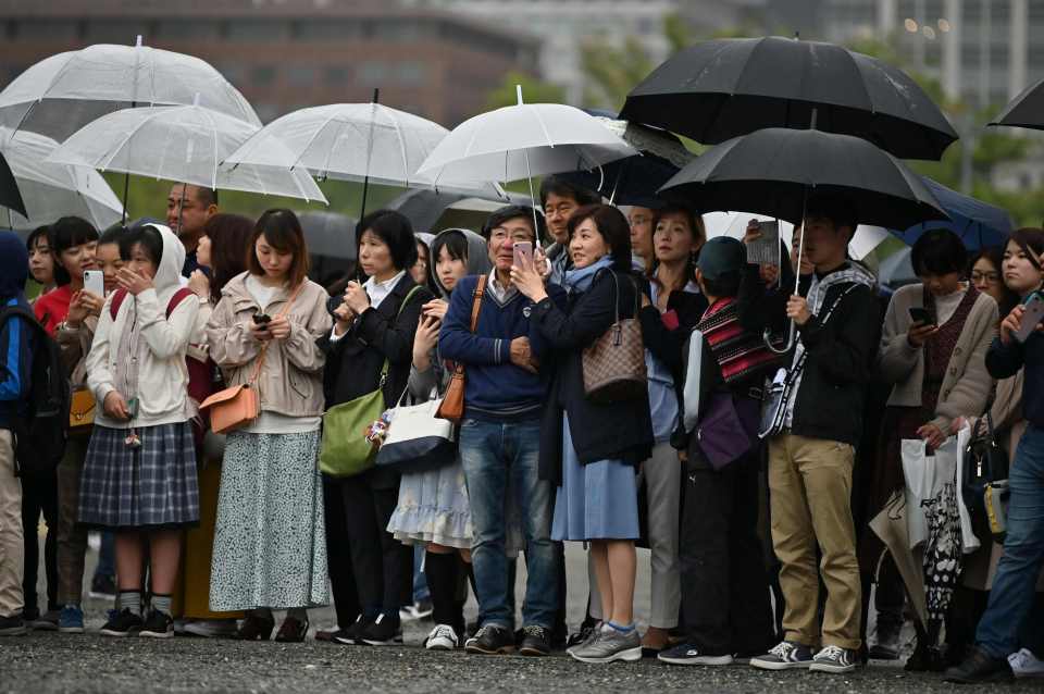  Well-wishers line streets to catch a glimpse of the 'People's Emperor'