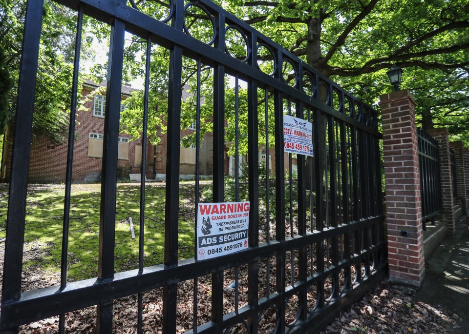  A warning sign appears on a gate that guards the abandoned mansion