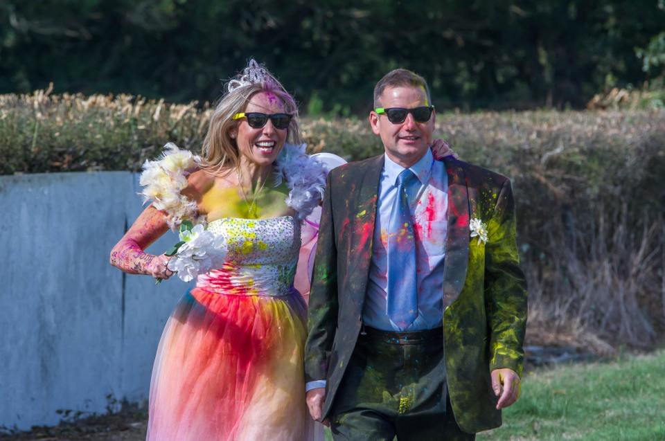  Michelle and John wore their wedding outfits the next day for an Age UK "powder paint" charity run