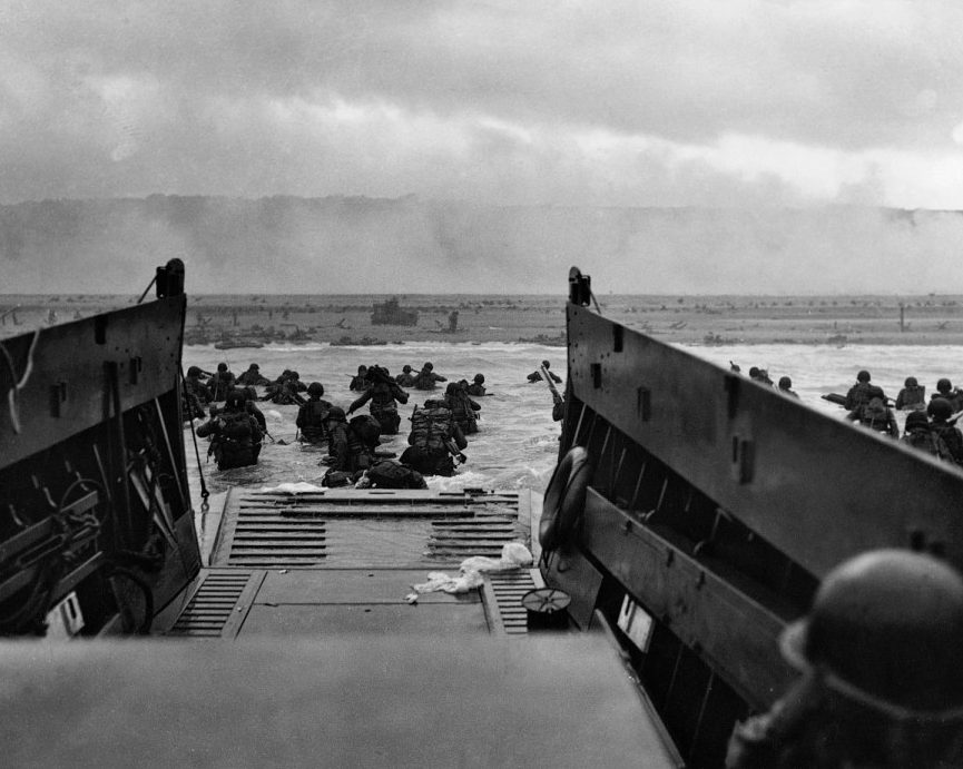  Troops wade ashore waist-deep in water on Omaha Beach