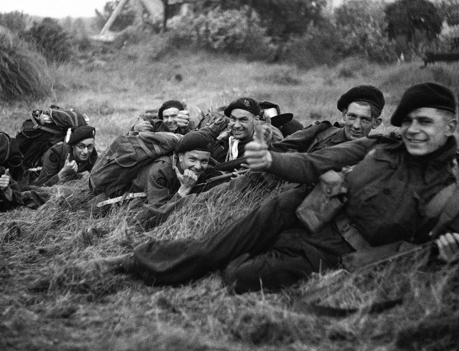  British Commandos give a confident thumbs-up to a combat photographer after coming ashore on Gold