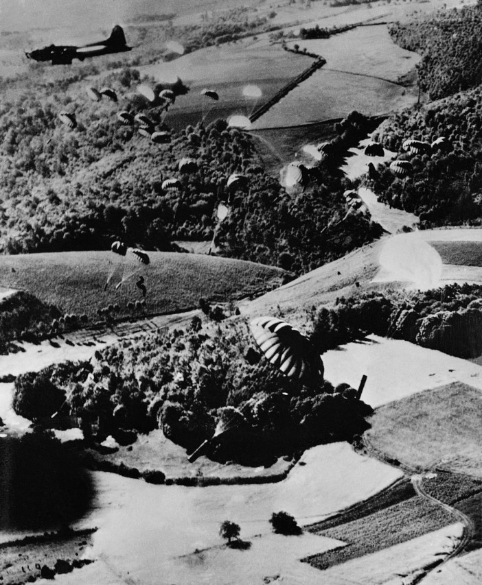  American Army Air Force B-17s drop weapons containers over a rural drop zone in France in one of the post D-Day missions