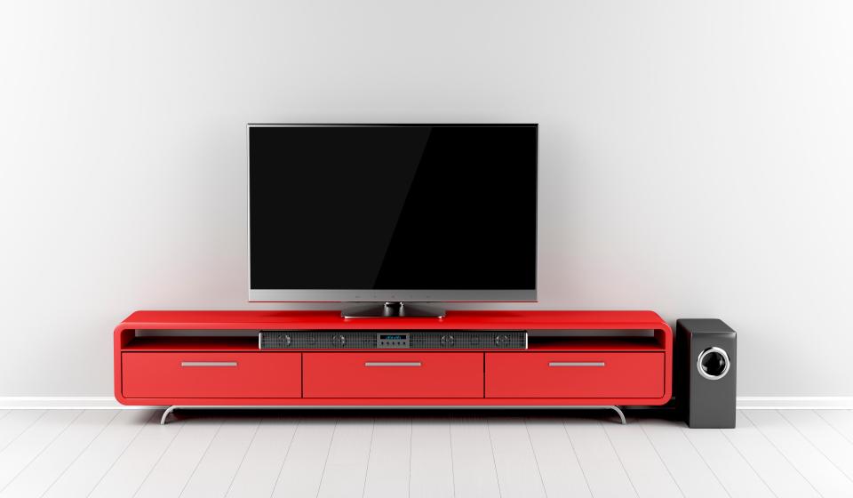 G3CB98 Tv with soundbar and subwoofer on tv stand