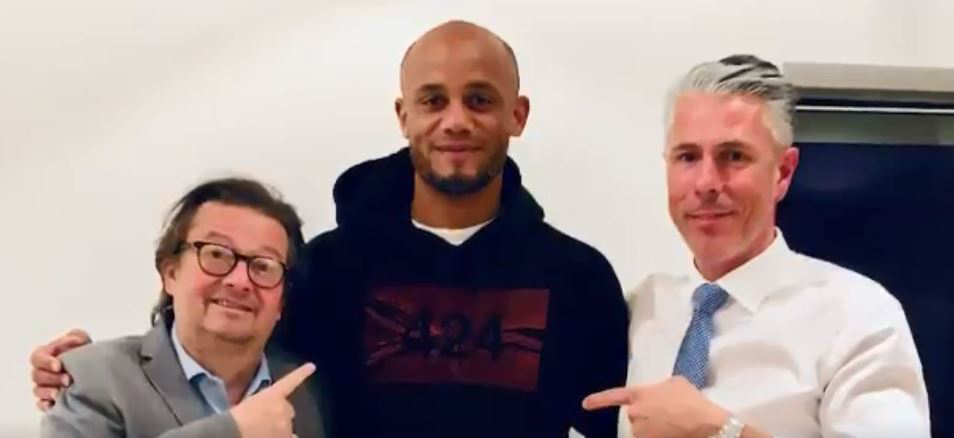  Kompany pictured with his new colleagues, Marc Coucke (left), chairman of Anderlecht, and senior board member Michael Verschueren