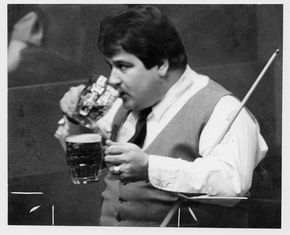 Bill Werbenuik with a pint in each hand during a snooker match