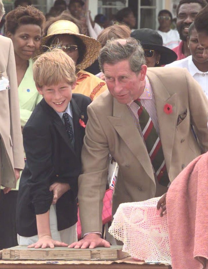 son Prince Harry leave their mark in cement, at the Dukuduku village school in South Africa