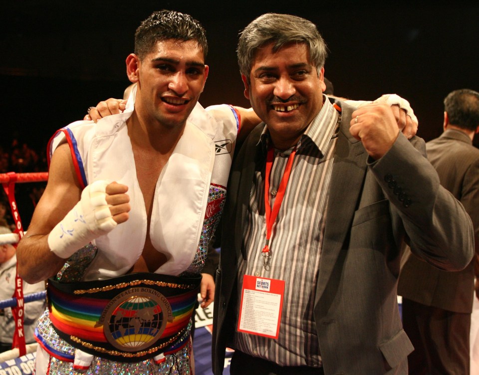 Amir with his father as they celebrated defeating Australia's Gairy St Clair in 2008