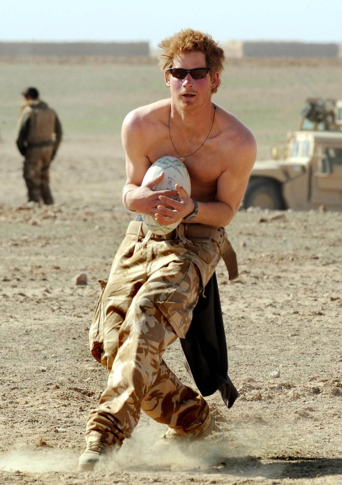 Prince Harry practices his rugby skills during a break in the desert on January 2, 2008 in Helmand Province, Afghanistan