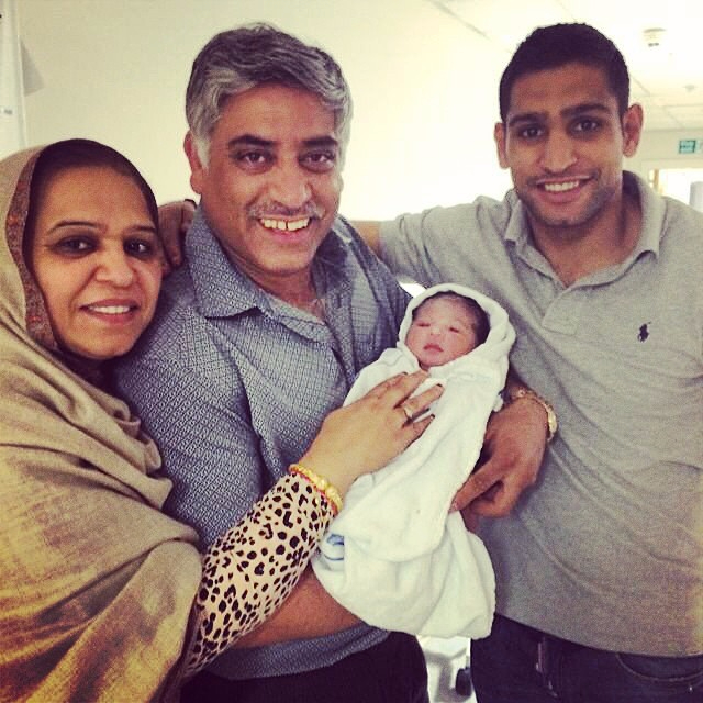 Amir with his parents after his second daughter, Alayna was born