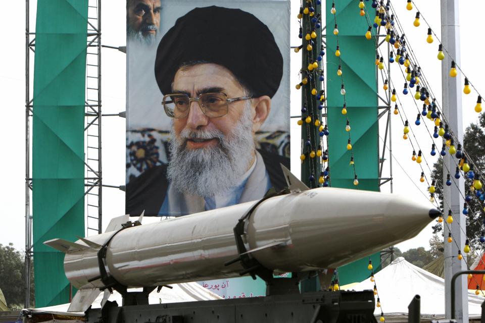  An Iranian missile stands on display in front of a large portrait of Iran's Supreme Leader Ayatollah Ali Khamenei in a square in south Tehran