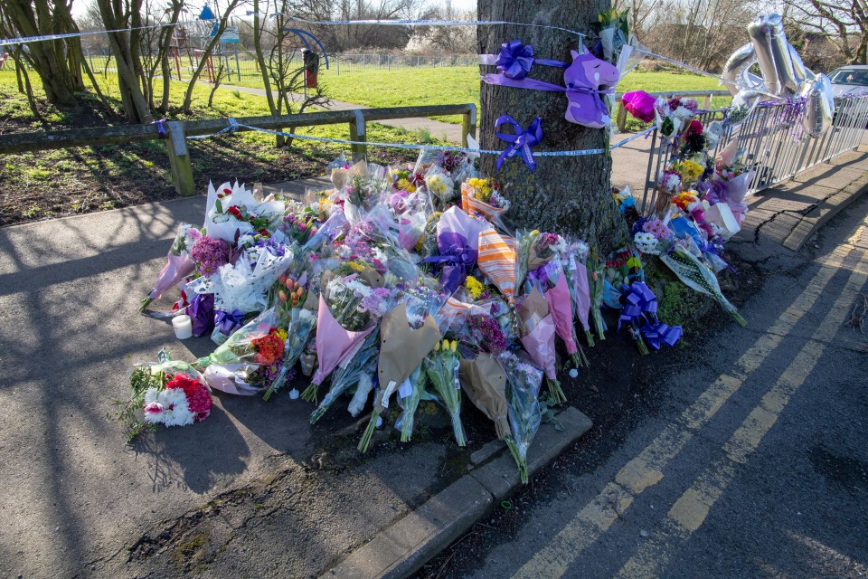  Floral tributes and purple ribbons were left at the scene